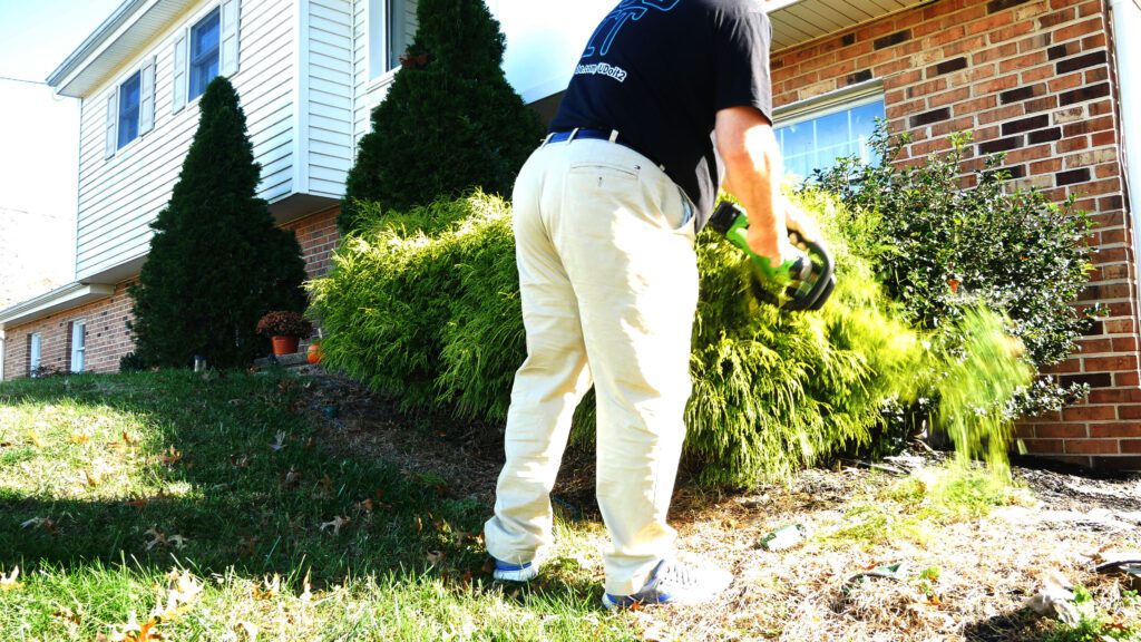 U Do It trimming a bush with the hedgetrimmer