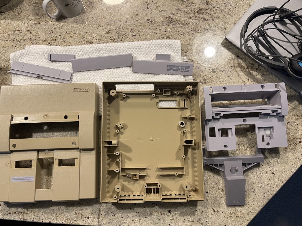 muttbunch disassembled super nintendo console plastic parts